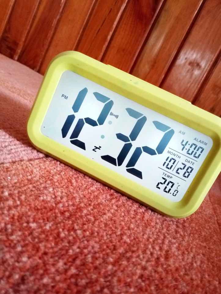 close up photography of yellow alarm clock
